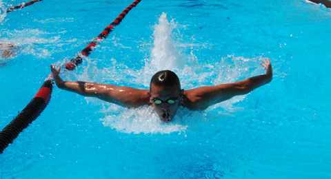A SAC student-athlete swimming