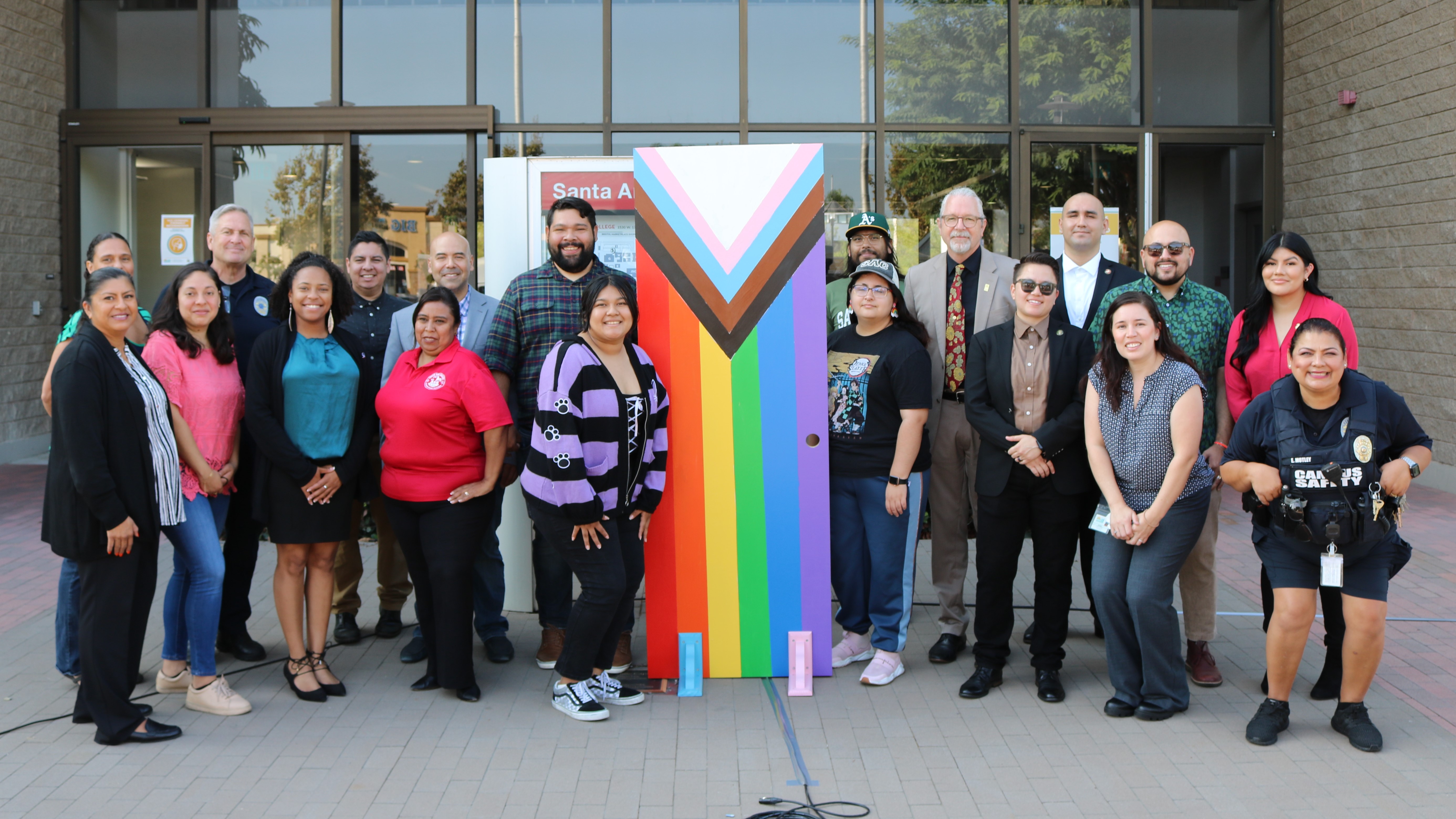 SAC students, faculty and staff in front of the pride flag