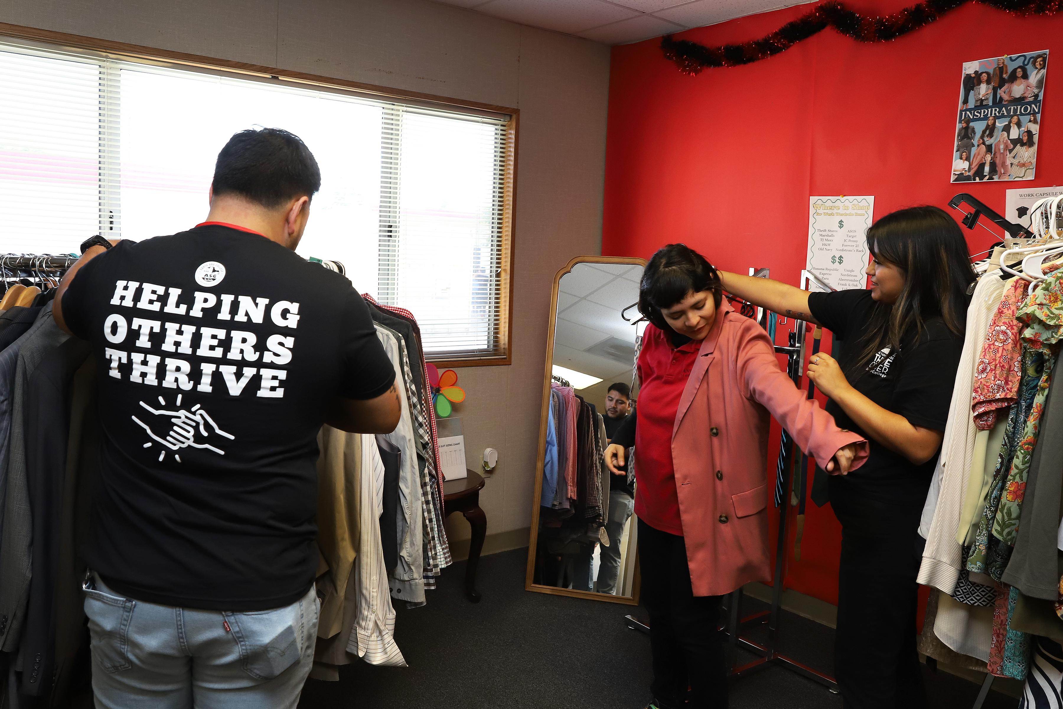 student workers assist female at career closet
