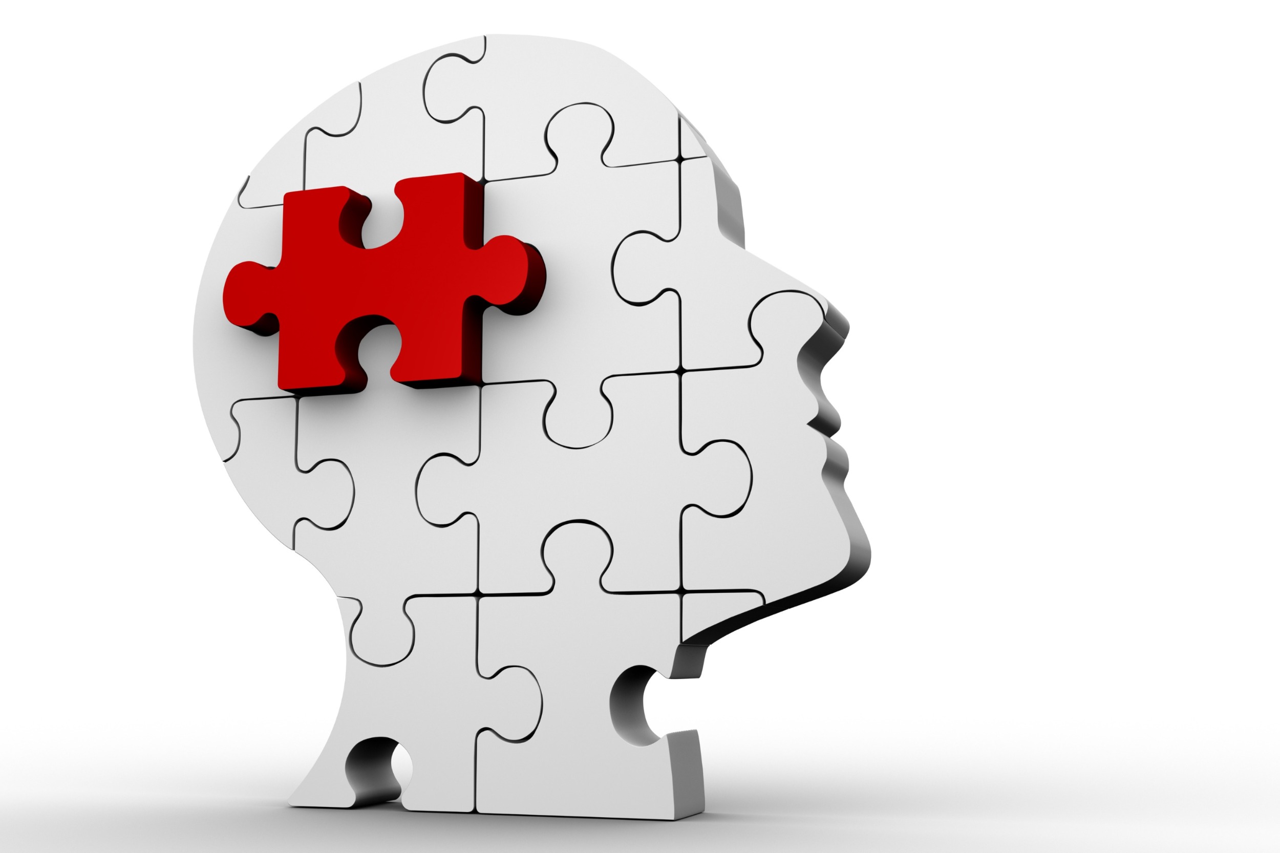 white jigsaws making shape of a head with one piece being red