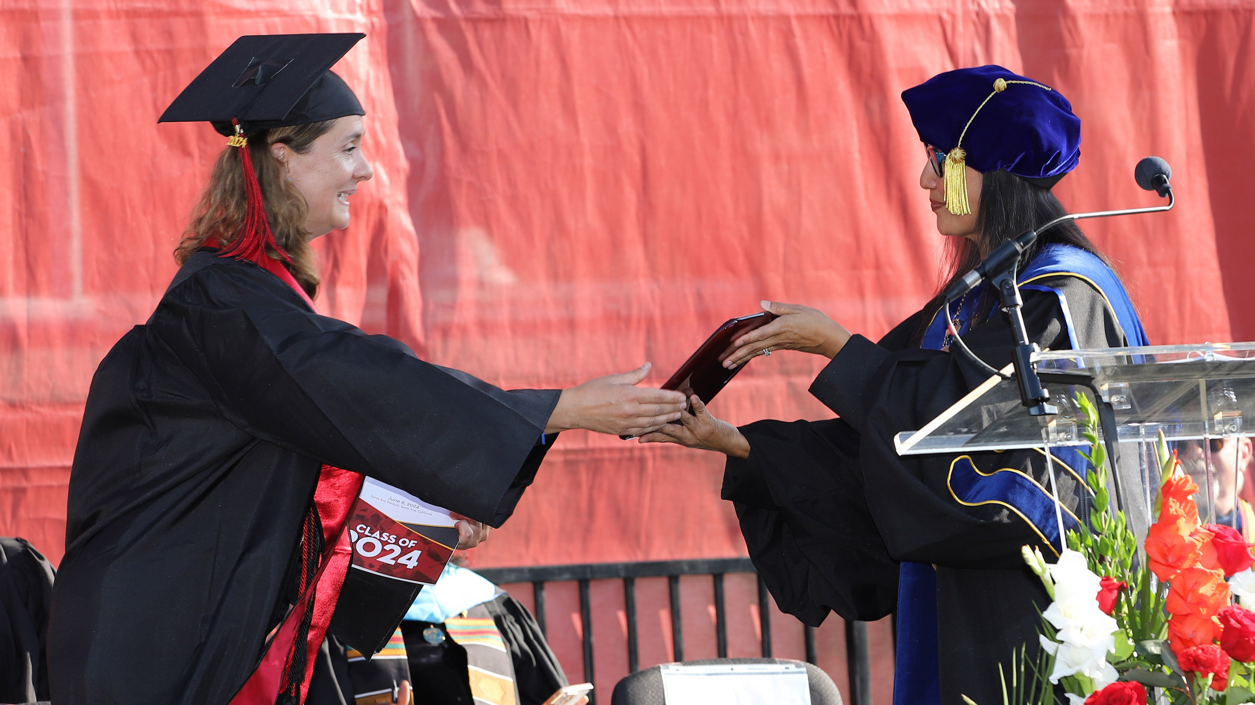 Lenka Capkova receives her Bachelor Degree diploma from Dr. Nery at 2024 commencement