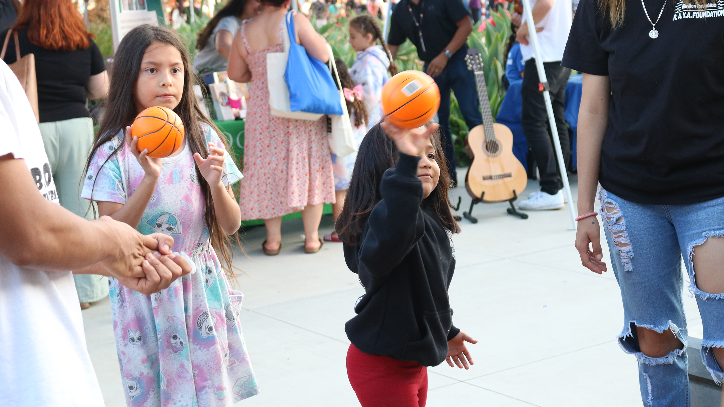 two little girls play a ball game at Family Night