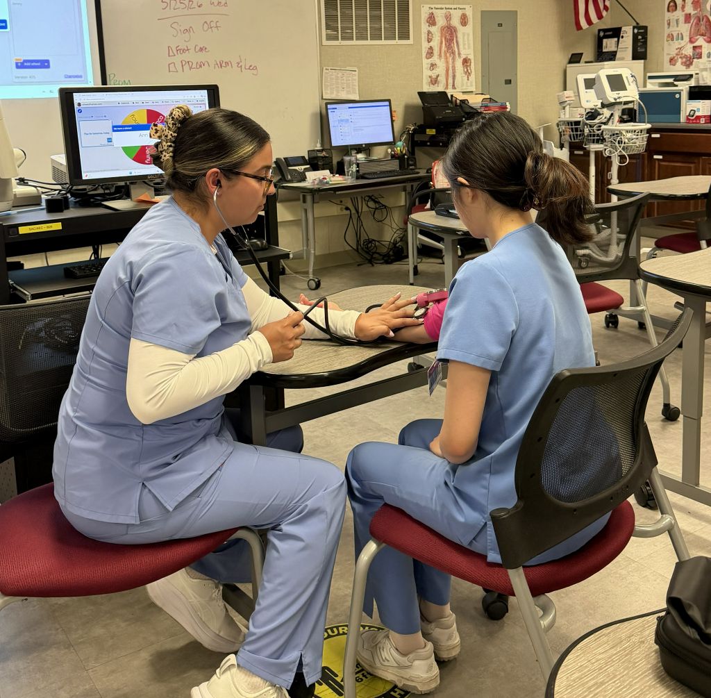Students practicing in lab to work as Acute Care Nursing Assistants with free classes at Santa Ana College School of Continuing Education