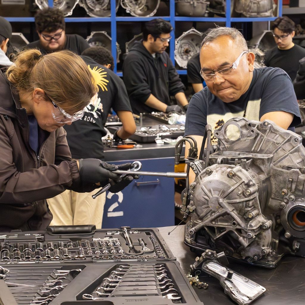 Diverse older students fixing an engine at Remington Education Center in Orange County, California