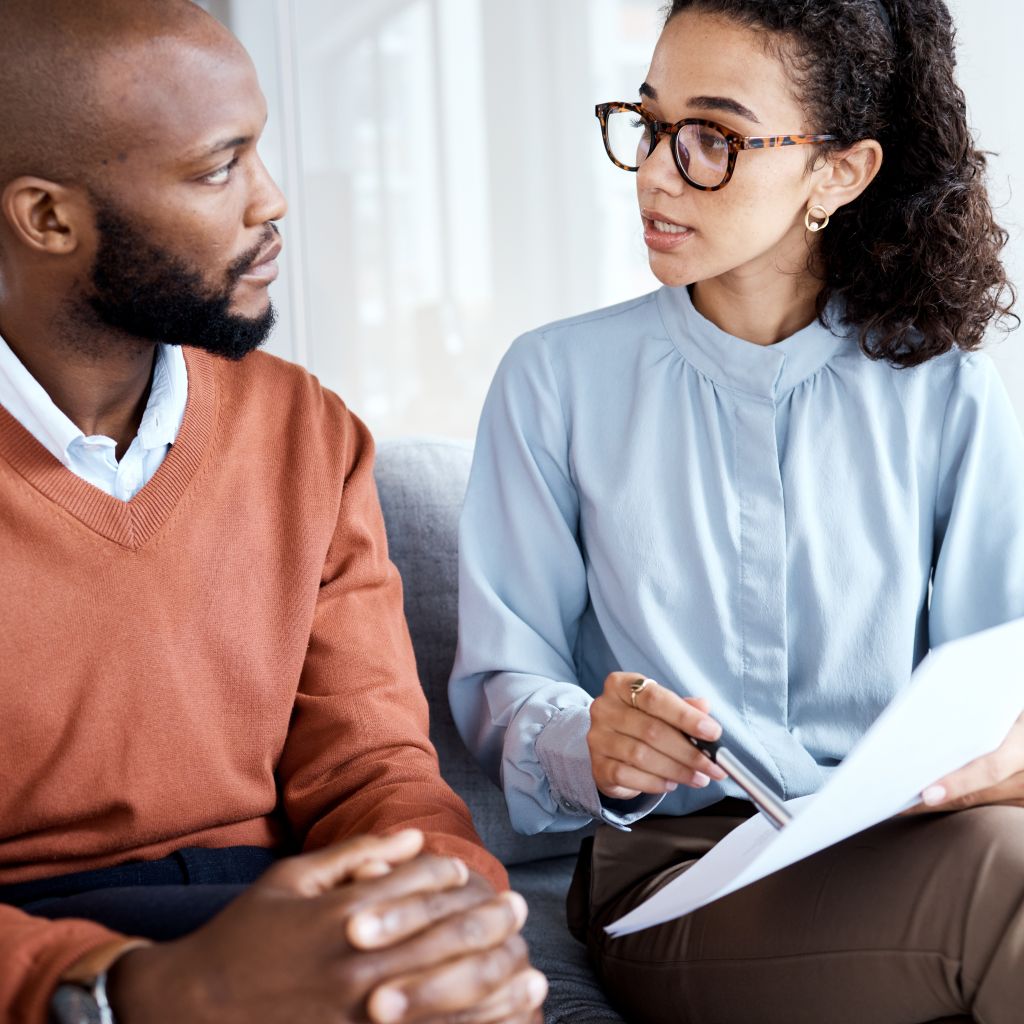 Woman working in Community Health, meeting with a patient to assist him through healthcare