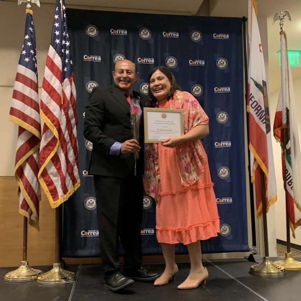 Continuing Education faculty Dr. Adrianna Gonzalez with 46th district congressman Lou Correa, receiving women of the year award
