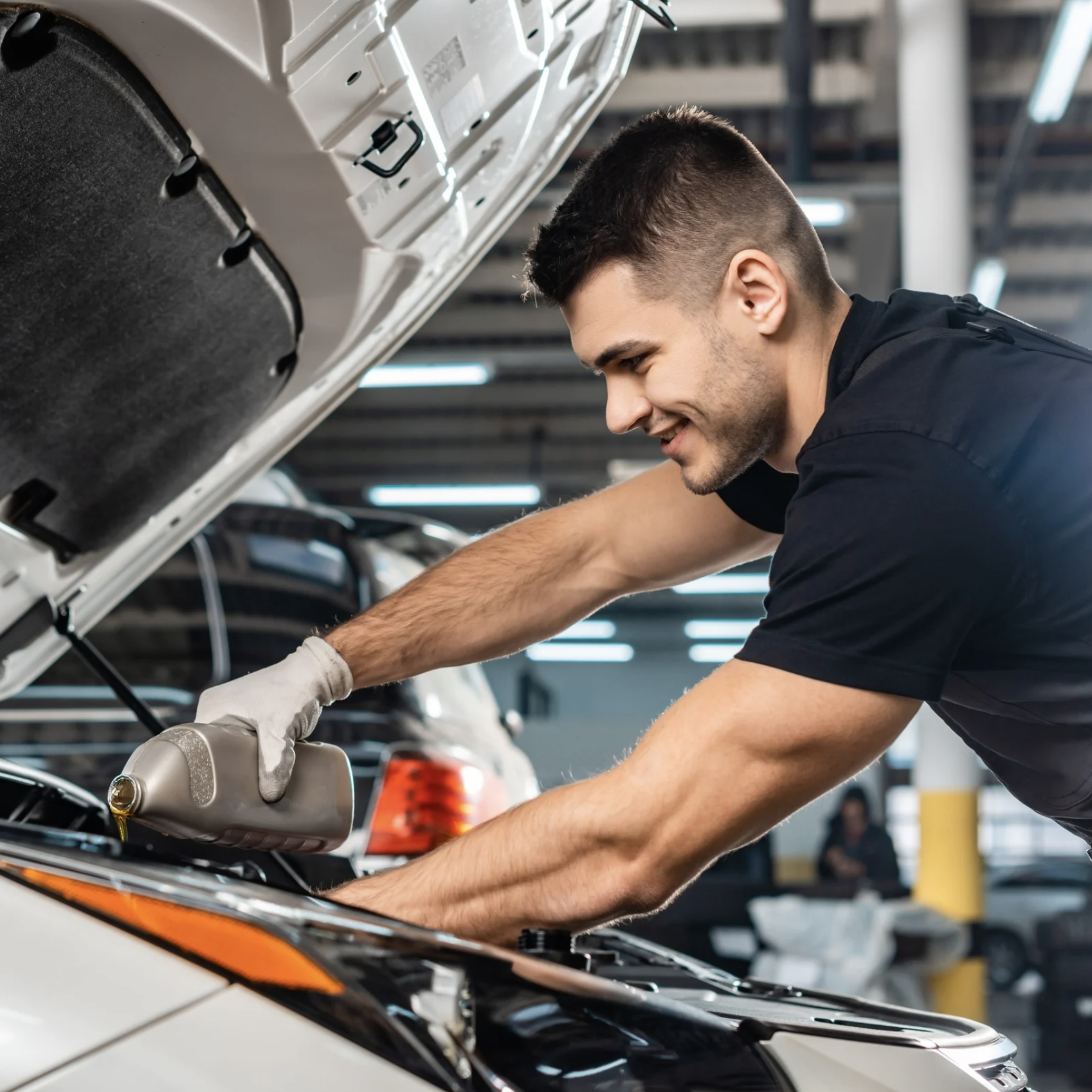 Young man working on the engine of a car