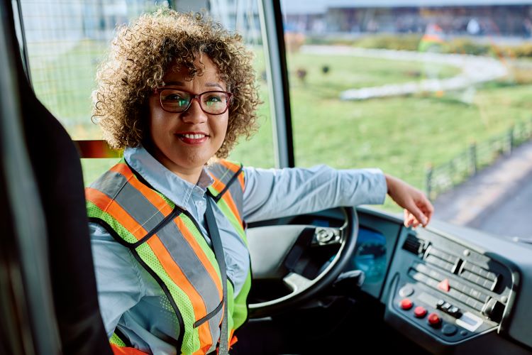 Female bus driver transporting people in Orange County with certification from Santa Ana College